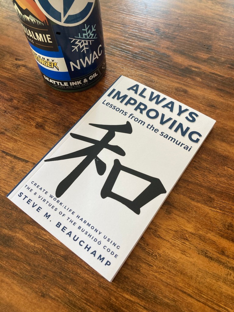 Always Improving book with metal water bottle